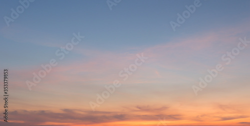 Fototapeta Naklejka Na Ścianę i Meble -  Beautiful sky painted by the sun leaving bright golden shades.Dense clouds in twilight sky in winter evening.Image of cloud sky on evening time.Evening sky scene with golden light from the setting sun