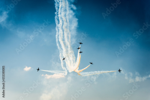 Formation of air planes on the blue cloudy sky during the airshow photo