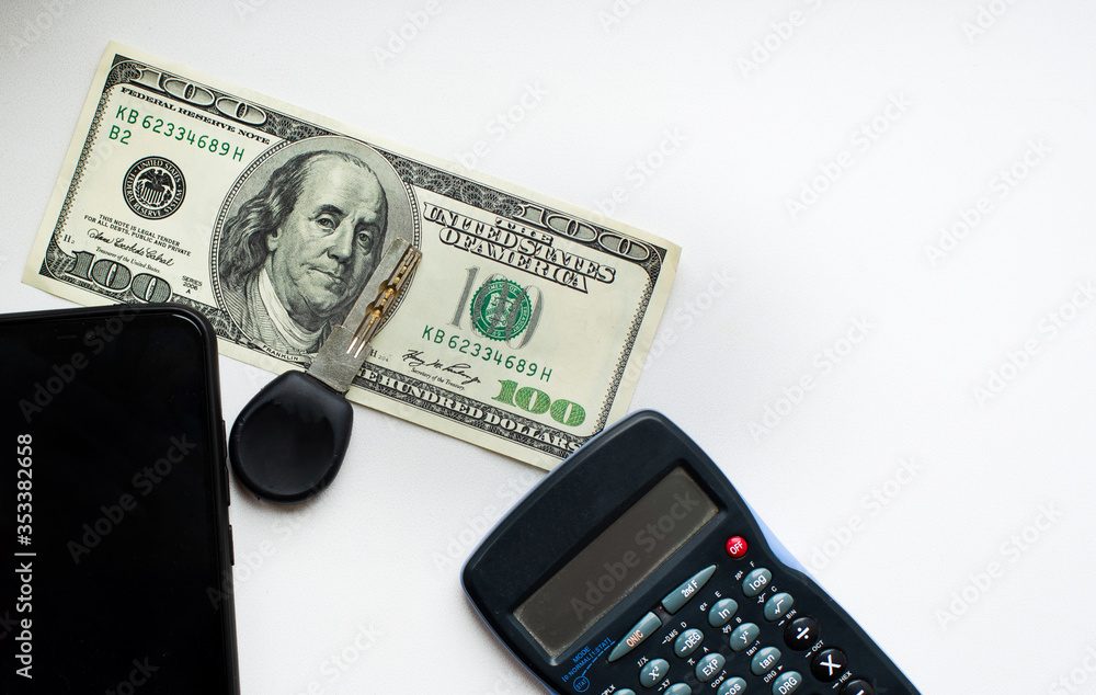 calculator key phone with white screen 100 dollars on white background calculator key phone with white screen 100 dollars on white background