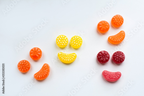 little fruit colored sweet lollipops isolated on white background