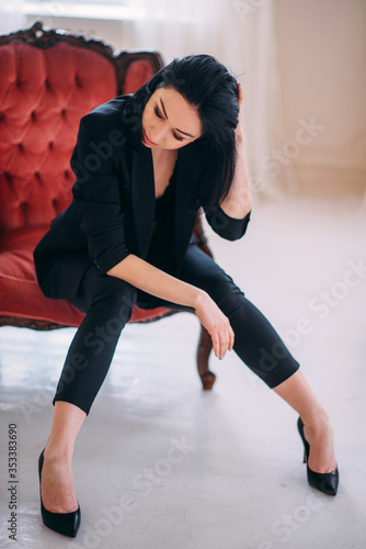 Depressed and tired businesswoman sitting on armchair.