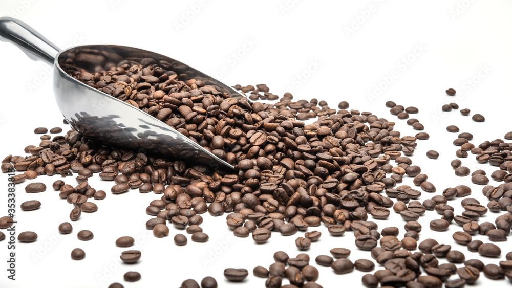 Spoon Coffee scoop and coffee beans roasted on a white background with copy space for your text