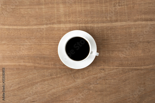 black coffee in a coffee cup top view isolated on wood background. with clipping path.