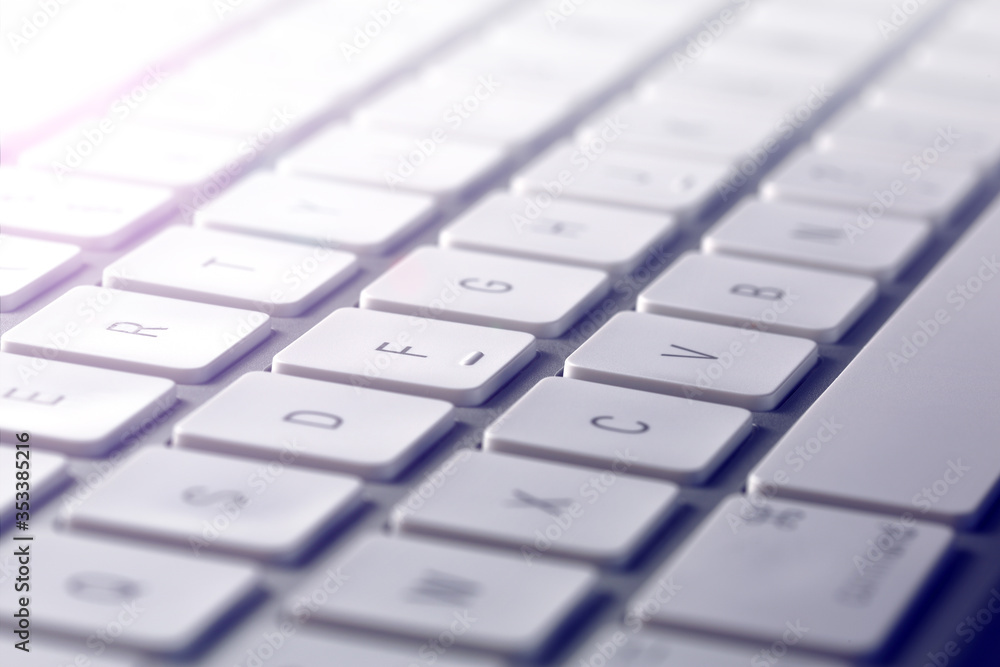 computer keyboard close up, detail of keys with light effect background computer keyboard close up, detail of keys with light effect background