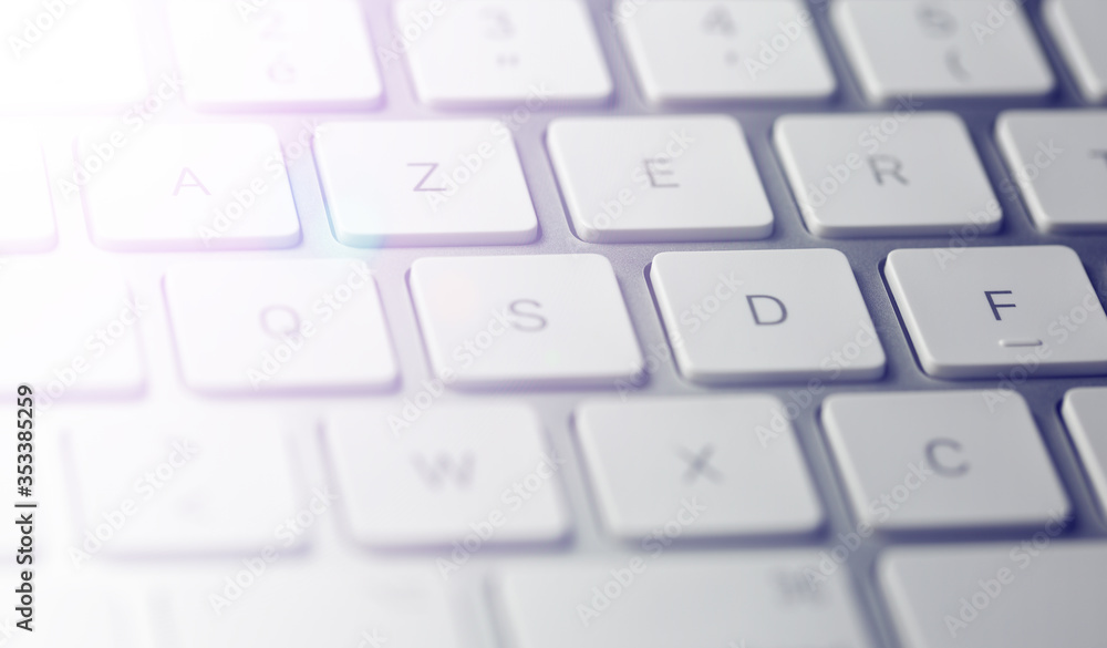 computer keyboard close up, detail of keys with light effect background computer keyboard close up, detail of keys with light effect background