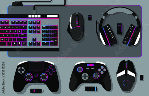 gamer workspace concept, top view a gaming gear, mouse, keyboard, joystick, headset, mobile joystick, in ear headphone and mouse pad on black table background.