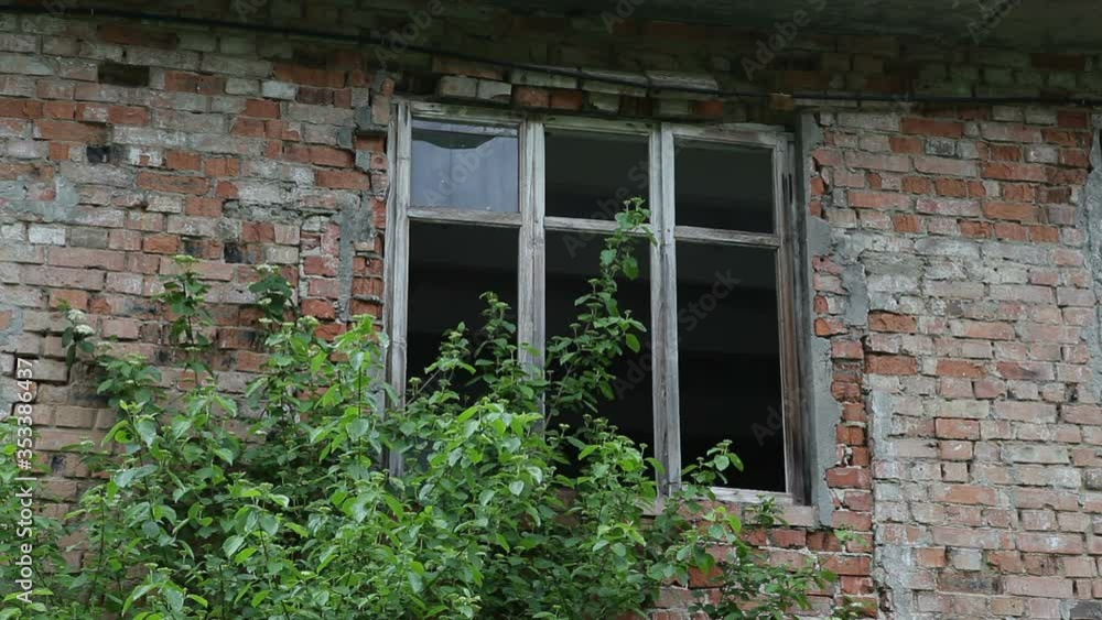 Broken window of an uninhabited old house.Abandoned house. Broken window of an uninhabited old house.Abandoned house.