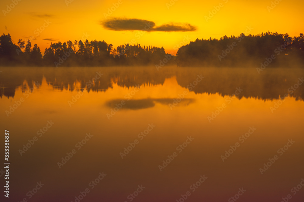 Fototapeta premium Magical sunrise over the lake. Serene lake in the early misty morning. Nature landscape