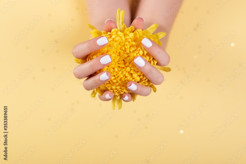 woman hands with manicure and wedding ring among white lace and little flowers woman hands with manicure and wedding ring among white lace and little flowers