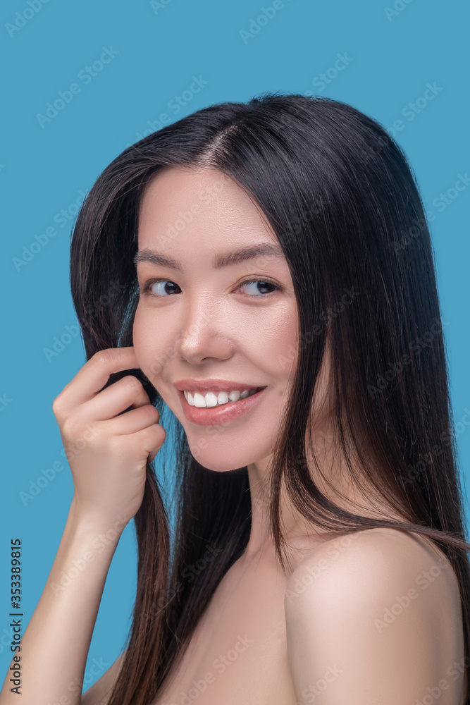 Beautiful woman with long and healthy hair smiling and looking great Beautiful woman with long and healthy hair smiling and looking great