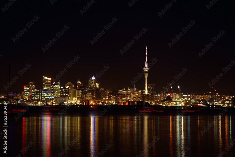 View over Auckland harbour at Auckland CBD skyline at night.