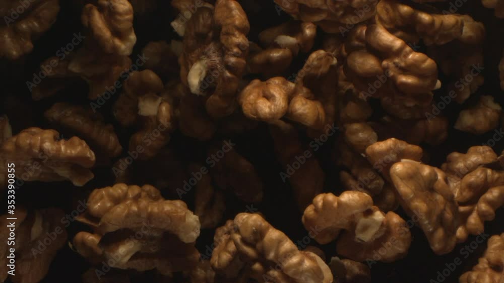 Walnut is Tossed in the Air on a Black Background Walnut is Tossed in the Air on a Black Background