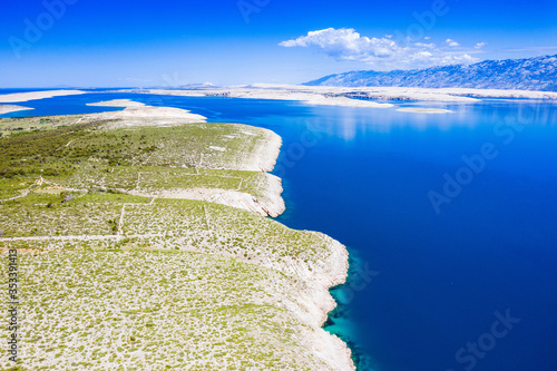 Croatia, Adriatic coastline in Vrsi, stone desert and view of the Pag island and Velebit mountain in background photo