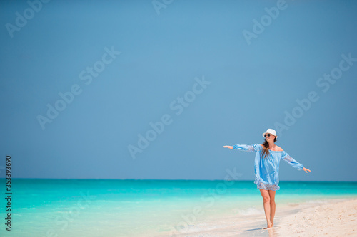 Young fashion woman in green dress on the beach © travnikovstudio