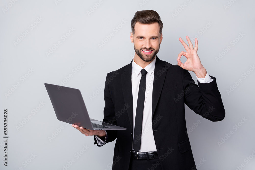 Portrait of confident smart entrepreneur man hold computer work project approve show okay sign wear formalwear outfit isolated over grey color background Portrait of confident smart entrepreneur man hold computer work project approve show okay sign wear formalwear outfit isolated over grey color background