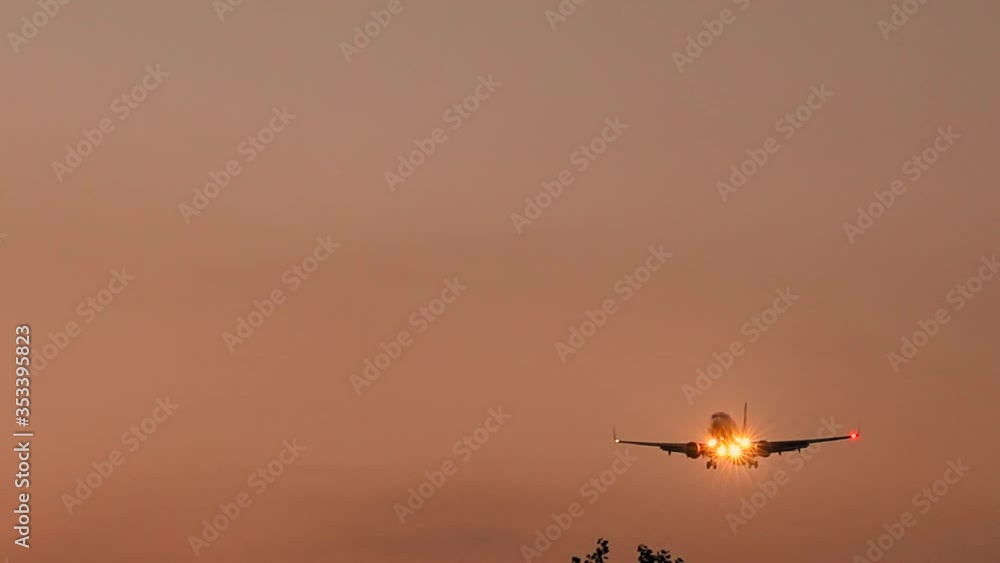 Airplane approach and landing at HAM Airport at sunset Airplane approach and landing at HAM Airport at sunset