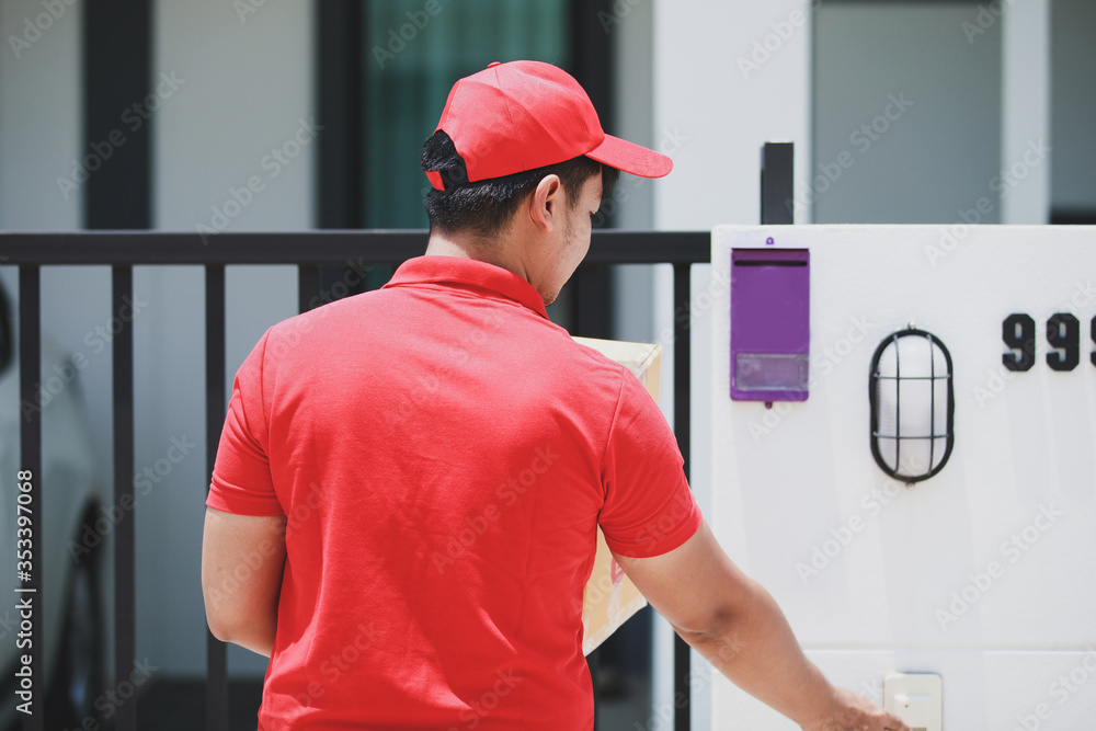 red delivery Man Holding Cardboard Box Ringing The Door Bell red delivery Man Holding Cardboard Box Ringing The Door Bell