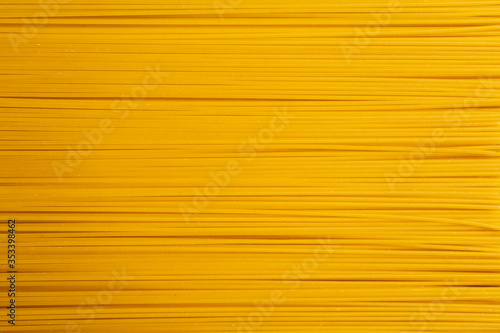 Background or texture of pasta of yellow color are located along the frame