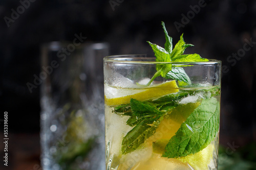 Homemade refreshing mojito cocktail in a tall glass photo