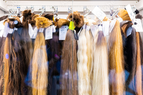 Exhibition of multicolored hair extensions in beauty salon