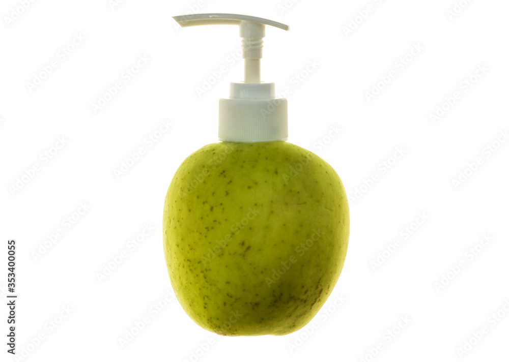 Obraz premium Green juicy apple with dispenser for soap or cosmetics on white isolated background.