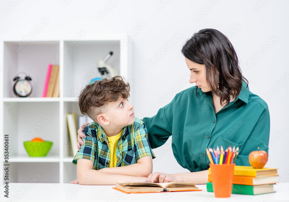 Psychologist talks to a boy at school Psychologist talks to a boy at school