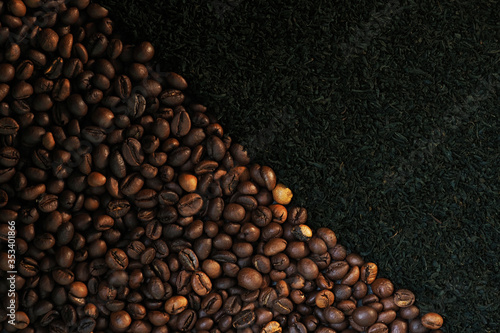 Coffee grains and black loose tea background. Coffee or tea, drink concept