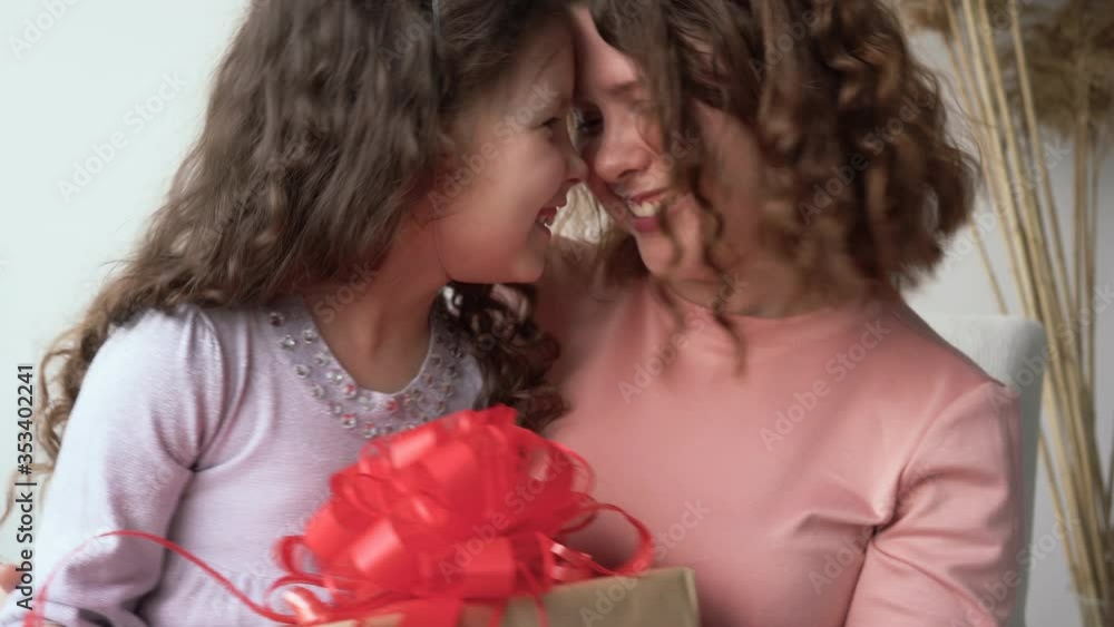 Happy birthday party. Mom and daughter hug each other. The concept of good relations between parents and children Happy birthday party. Mom and daughter hug each other. The concept of good relations between parents and children