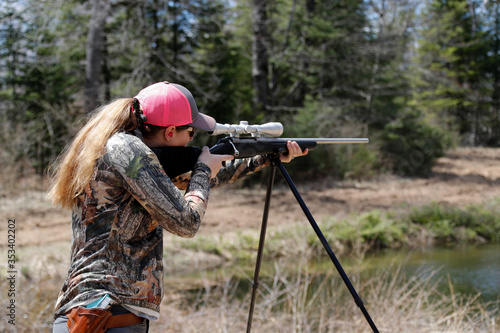 Woman aiming a rifle.