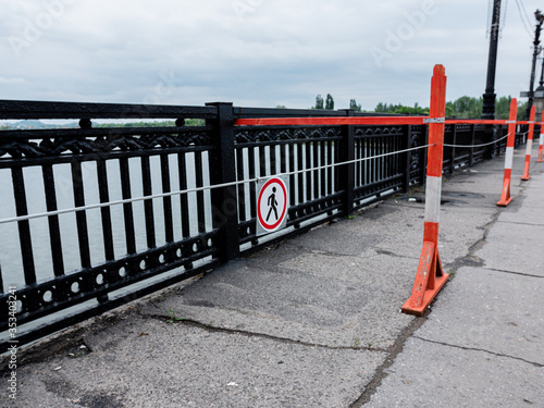 Barrier warning fencing of a dangerous place on bridge, nobody.