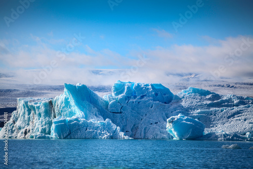 Icebergs floating. Ices and volcanic ash. Glacier lagoon. Melting ice. South coast Iceland.Volcanic ash on the arctic ice. Ice age glacier crevasse melting fast. Global warming. The edge of a glacier