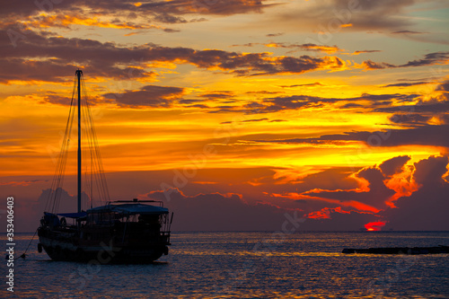 View of boat silhouette with sunset light take photo from Phangan island, Thailand