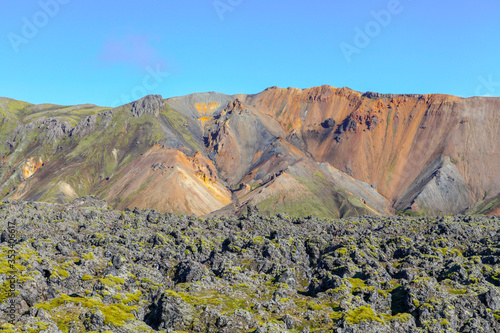 Landscape in Iceland. Green moss over the volcanic mountains and lava fields in Landmannalaugar national park. Beautiful colored mountains and lava fields.Surreal nature scenery in highland.