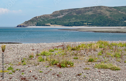 Hills rise rise up behind the stoney beach at Porlock Weir in Somerset, UK