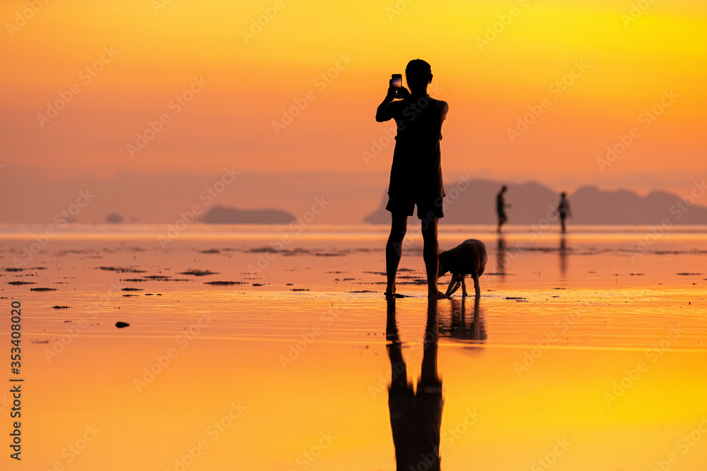 Silhouette of people to see the sea and sunset along the coastline at Hin Kong Beach Phangan Island, Thailand. Feb 05 2019