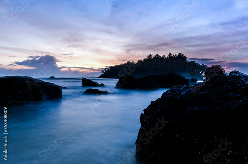 Dramatic  Beach sunset view colorful sky with black rock  evening shot from  Dharmadam Island Kerala, Beautiful Beach Landscape scenery photo