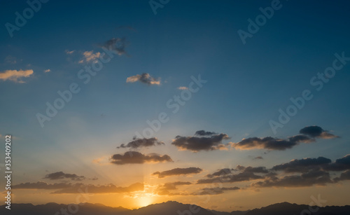 Colorful sunrise with clouds above mountains, Middle East