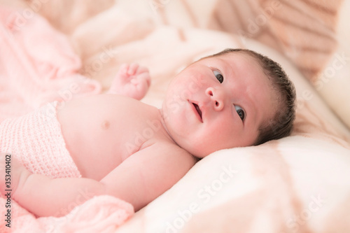Cute newborn Asian baby girl lying on the bed