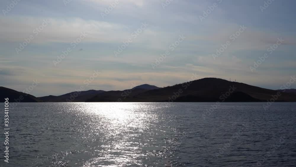 Sunshine reflected in water of lake forming a sun path or way of light on water surface Sunshine reflected in water of lake forming a sun path or way of light on water surface
