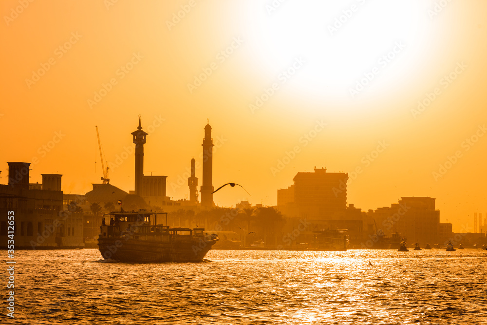 Fototapeta premium Old Dubai Traditional Abra boat ride , beautiful sunset view of old Dubai