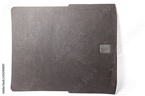 Obraz na plátně Fabric lining of the trunk floor of a gray car with a plastic clip as a separate part on a white isolated background in a photo studio for sale or replacement of material in a auto studio