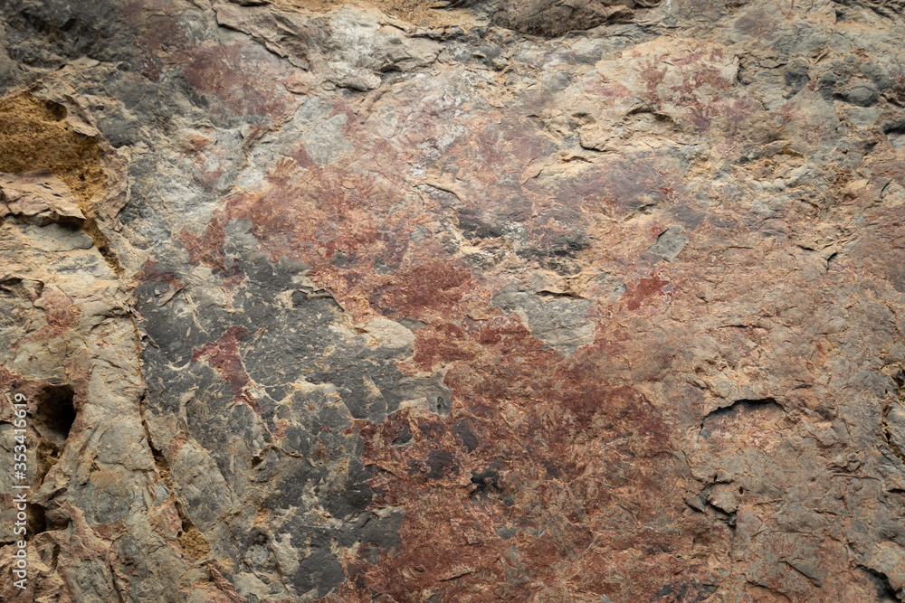 Ancient paintings painted by prehistoric people on the cliffs showing various stories of that era.