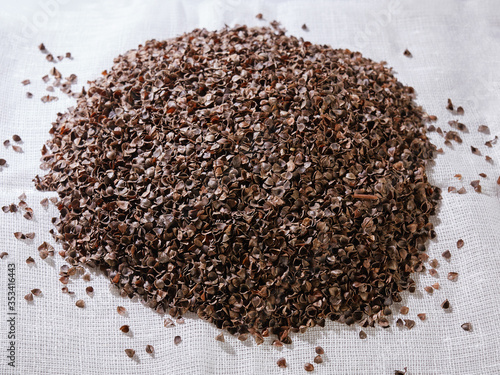 filler for pillows. buckwheat husk on a white background.