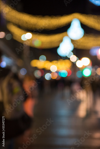 Christmas lights with blur bokeh. Night lights on street. Bokeh light abstract background.. © resul