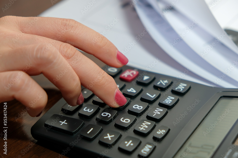 Financial data analyzing hand writing and counting on calculator at home on wooden desk,Business and finance concept.. Financial data analyzing hand writing and counting on calculator at home on wooden desk,Business and finance concept..