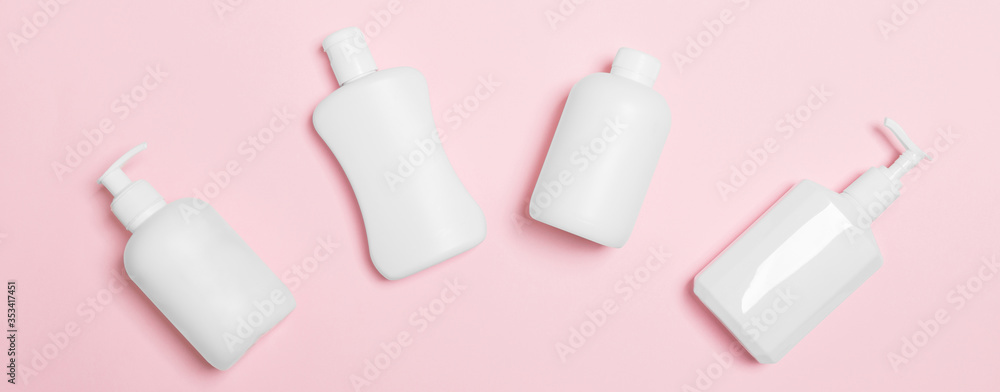 Set of White Cosmetic containers isolated on pink background, top view with copy space. Group of plastic bodycare bottle containers with empty space for you design Set of White Cosmetic containers isolated on pink background, top view with copy space. Group of plastic bodycare bottle containers with empty space for you design