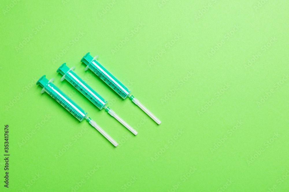 Top view of syringes in a row for medical injection on colorful background with copy space. Health and vaccination concept Top view of syringes in a row for medical injection on colorful background with copy space. Health and vaccination concept