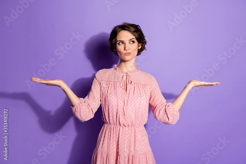 Portrait of her she nice-looking attractive lovely doubtful girl holding copy space on palms making decision isolated over bright vivid shine vibrant lilac violet purple color background