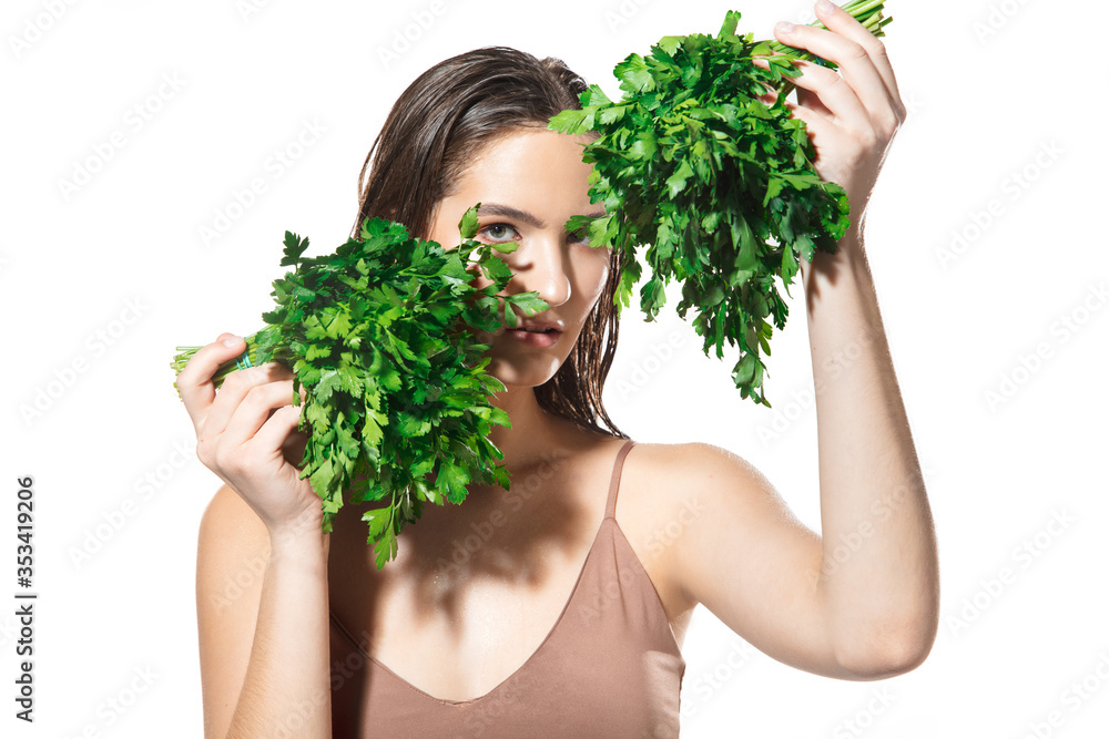 Green splash. Close up of beautiful young woman with parsley on white background. Concept of cosmetics, makeup, natural and eco treatment, skin care. Shiny and healthy skin, fashion, healthcare. Green splash. Close up of beautiful young woman with parsley on white background. Concept of cosmetics, makeup, natural and eco treatment, skin care. Shiny and healthy skin, fashion, healthcare.