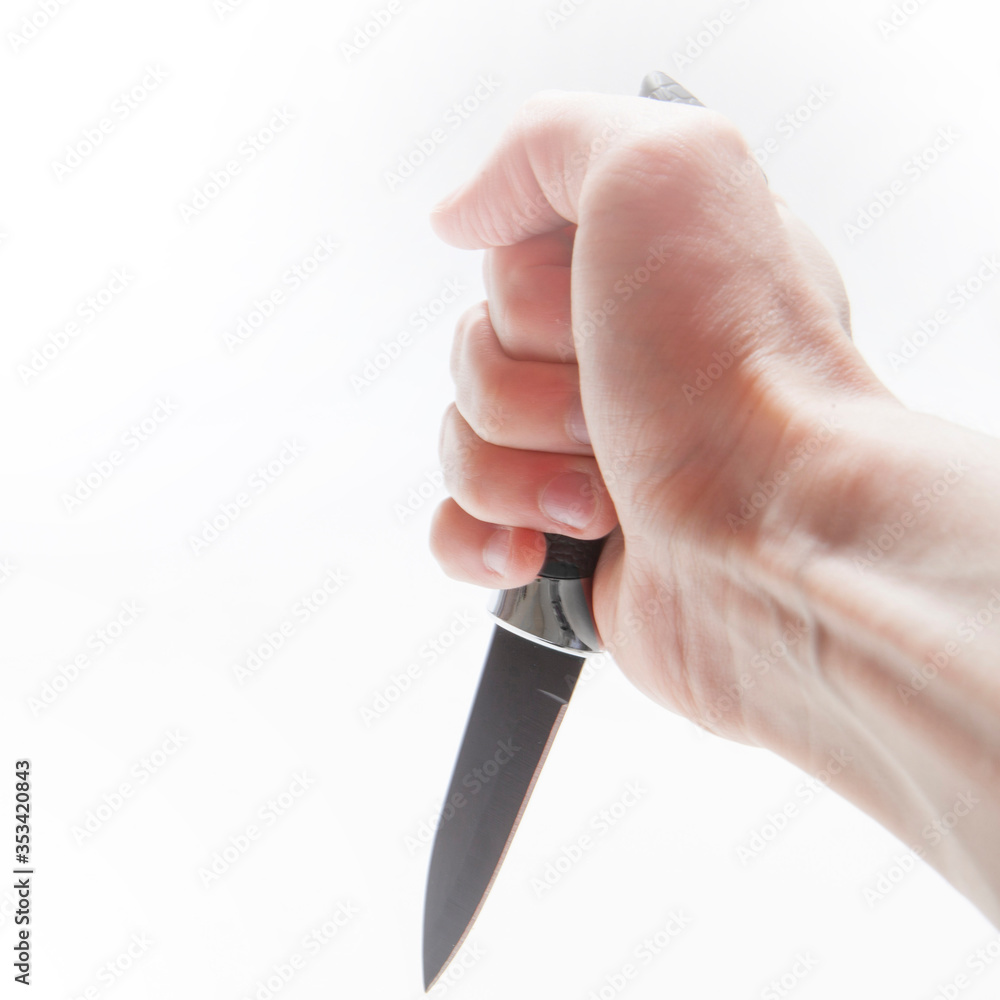 Knife in a man's hand on a white background Knife in a man's hand on a white background